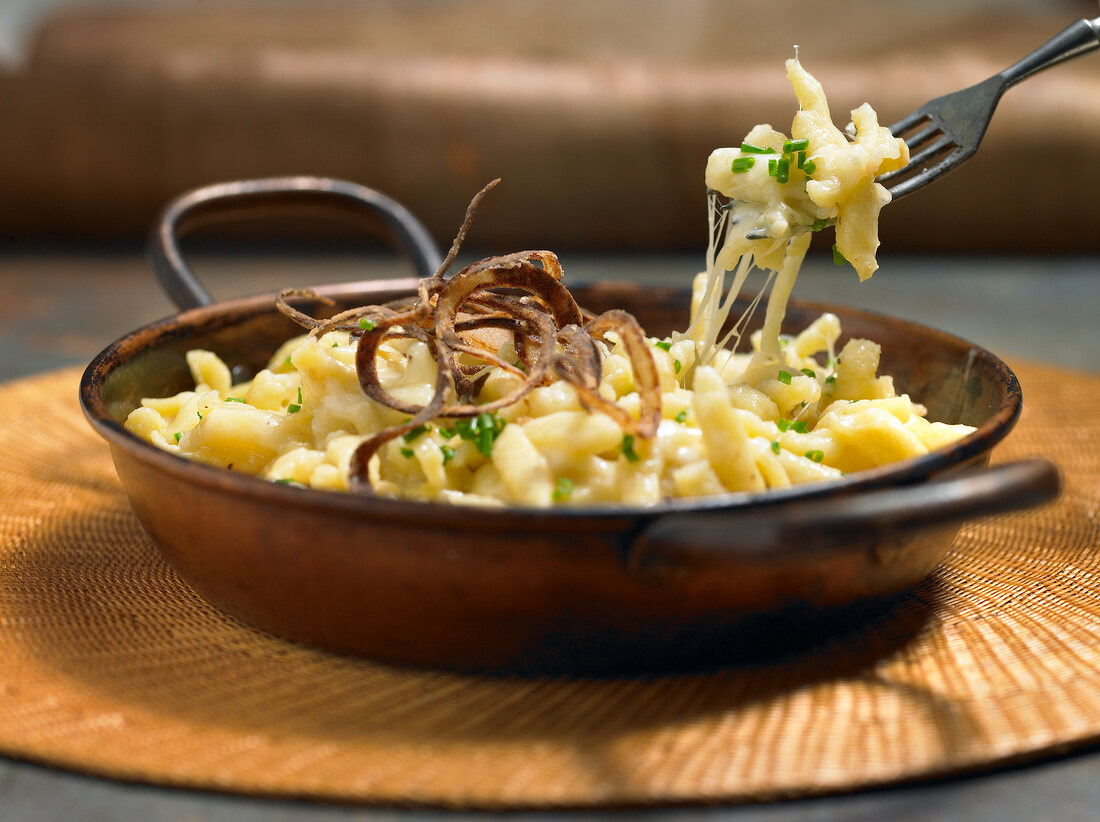 Cheese spatzle in wok and fork