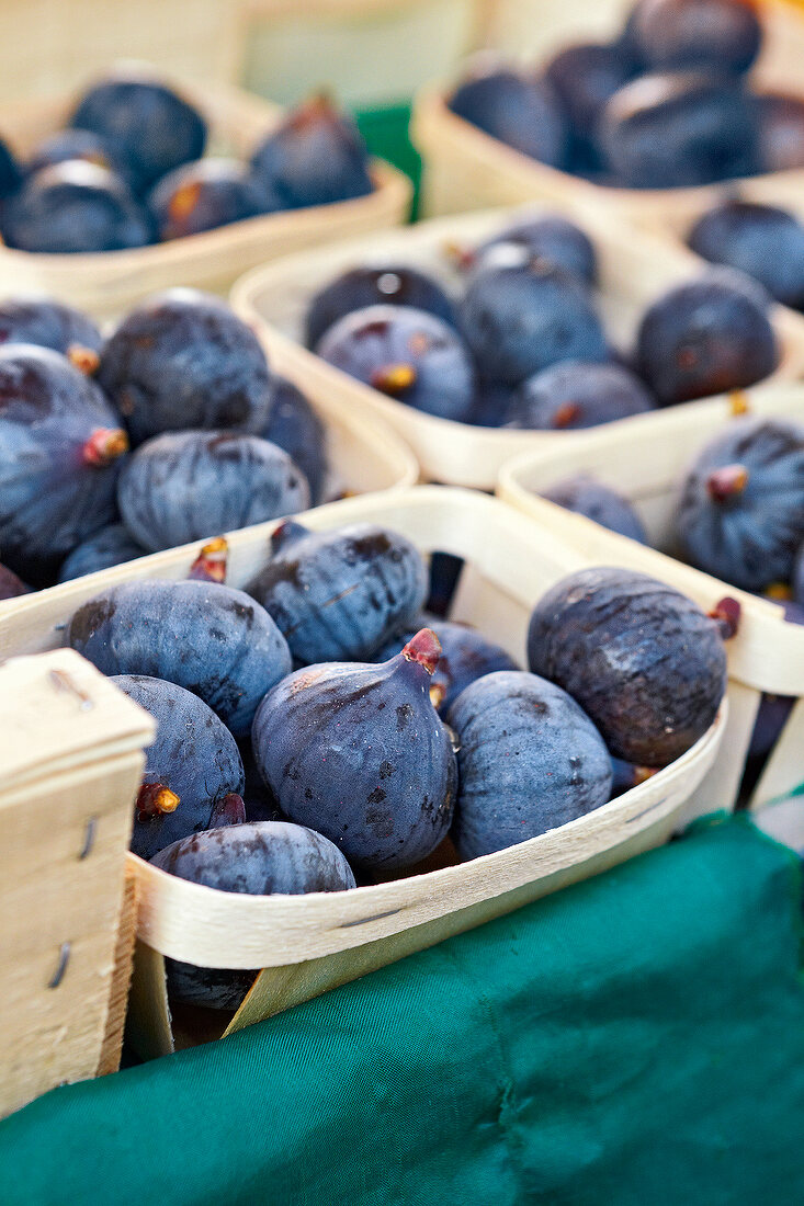 Close-up of figs in baskets