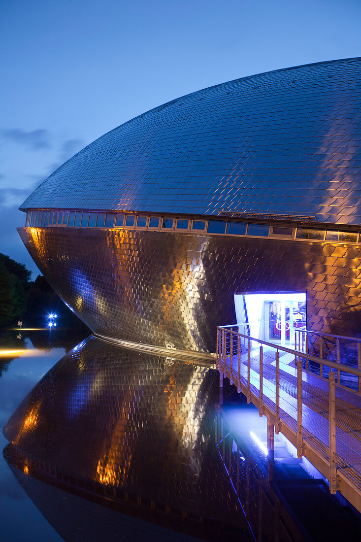 Symmetrical reflection of Atlantic Hotel Universum at night, Bremen, Germany