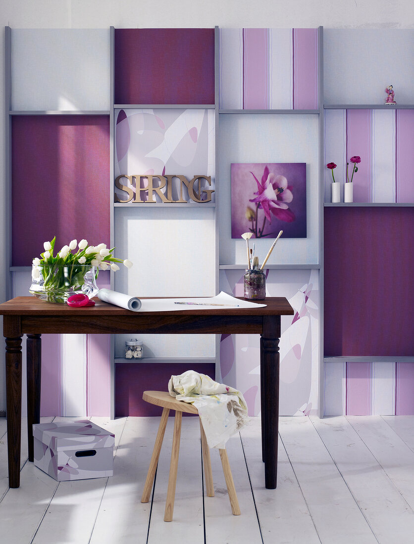 Room with table against pink striped wallpaper