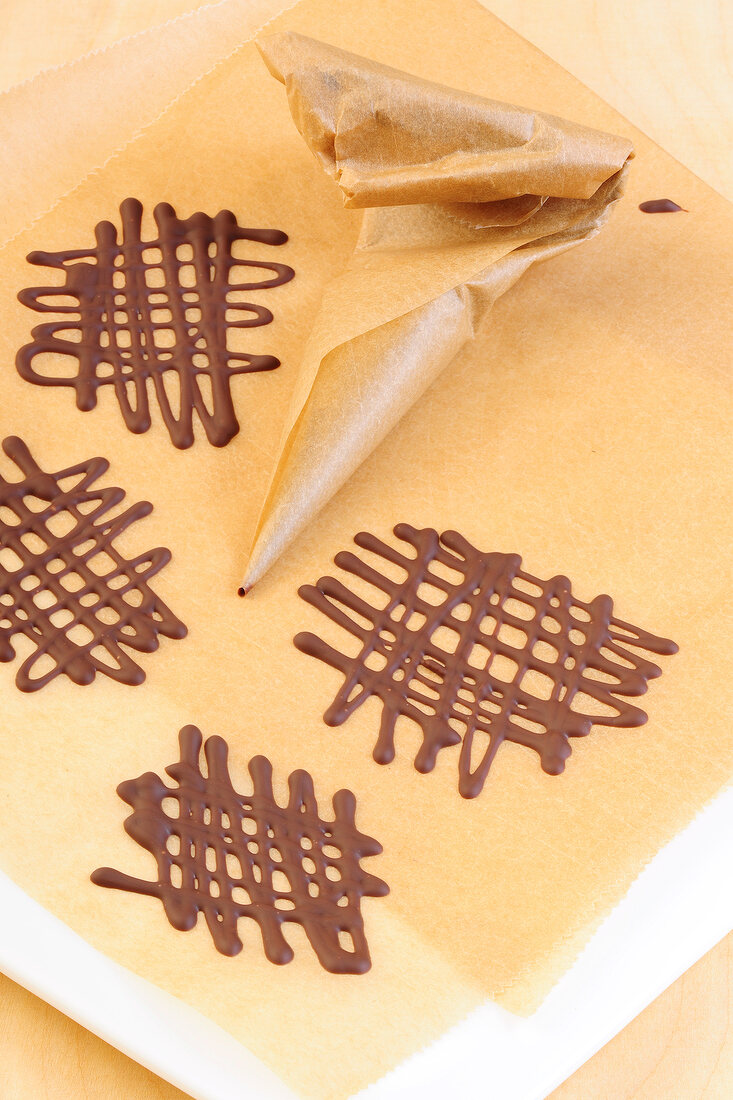 Various chocolate lattice with cone on paper for preparation of desserts
