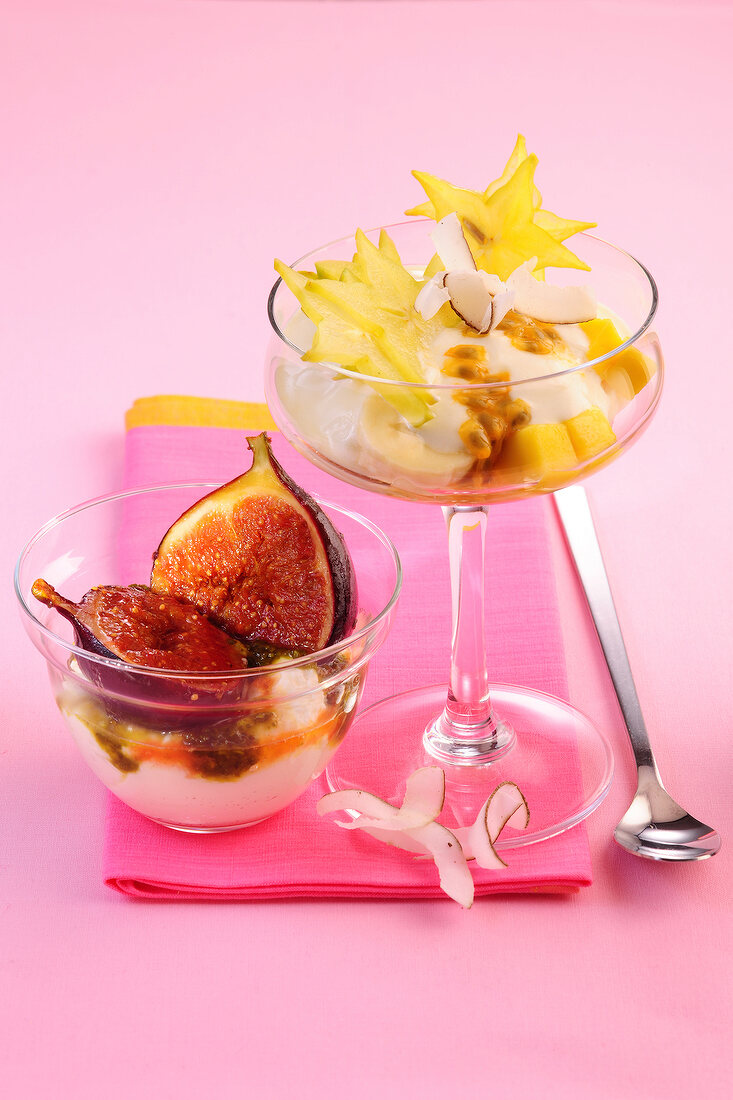 Pistachio yogurt with figs in glass bowl and lime yogurt with fruit in glass