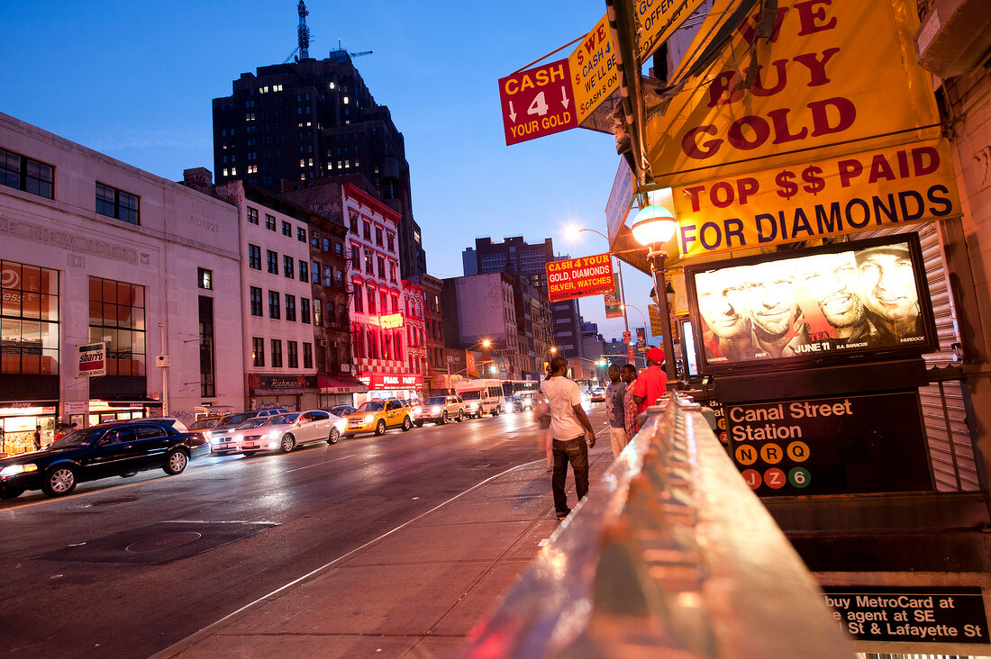 Low angle view of people at Broadway in SoHo at night, New York, USA