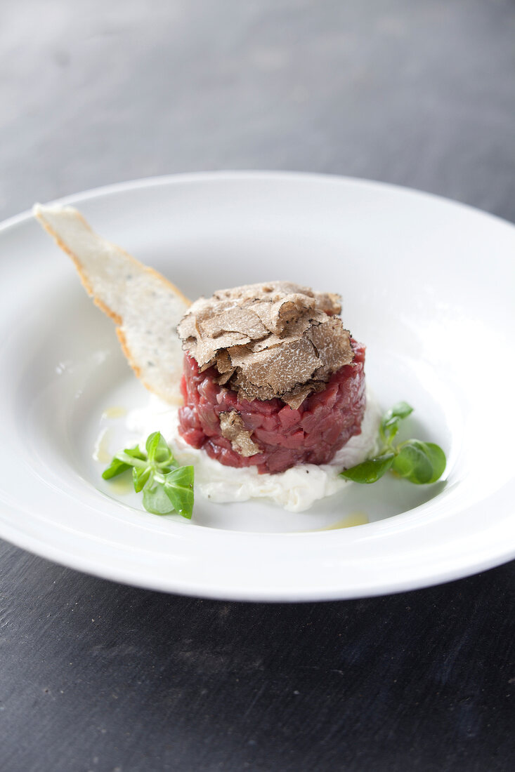 Close-up of beef tartare with truffles in serving dish