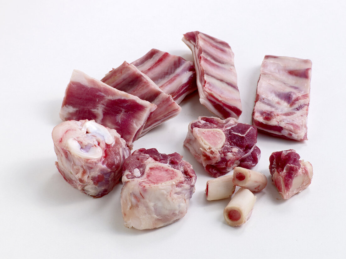 Pieces of lamb carcasses on white background