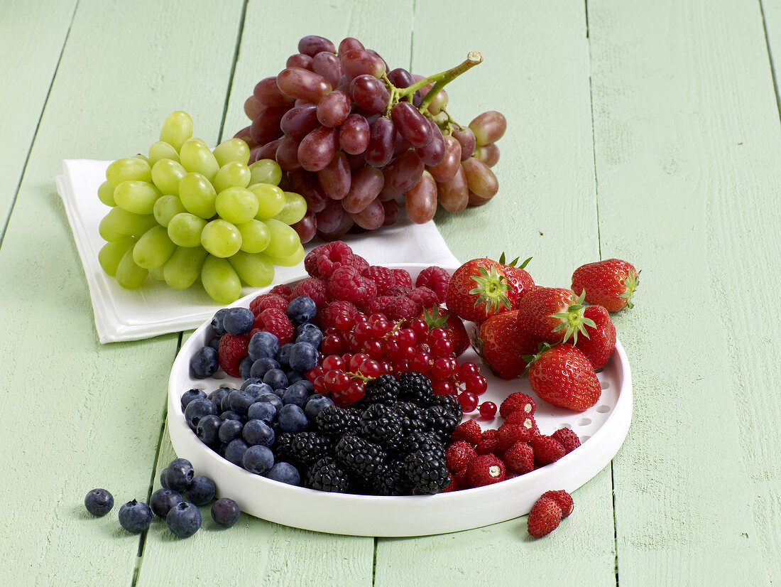 Fresh grapes and berries on plate