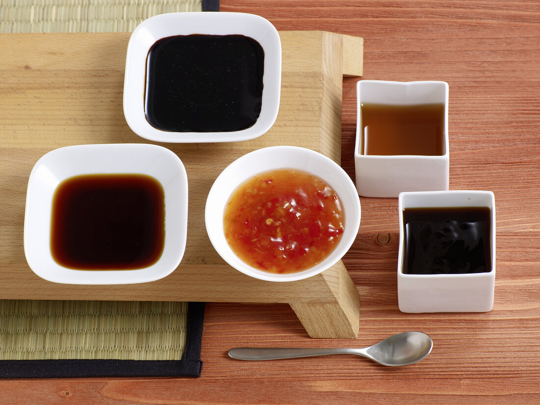 Different types of spicy Asian sauces in bowls