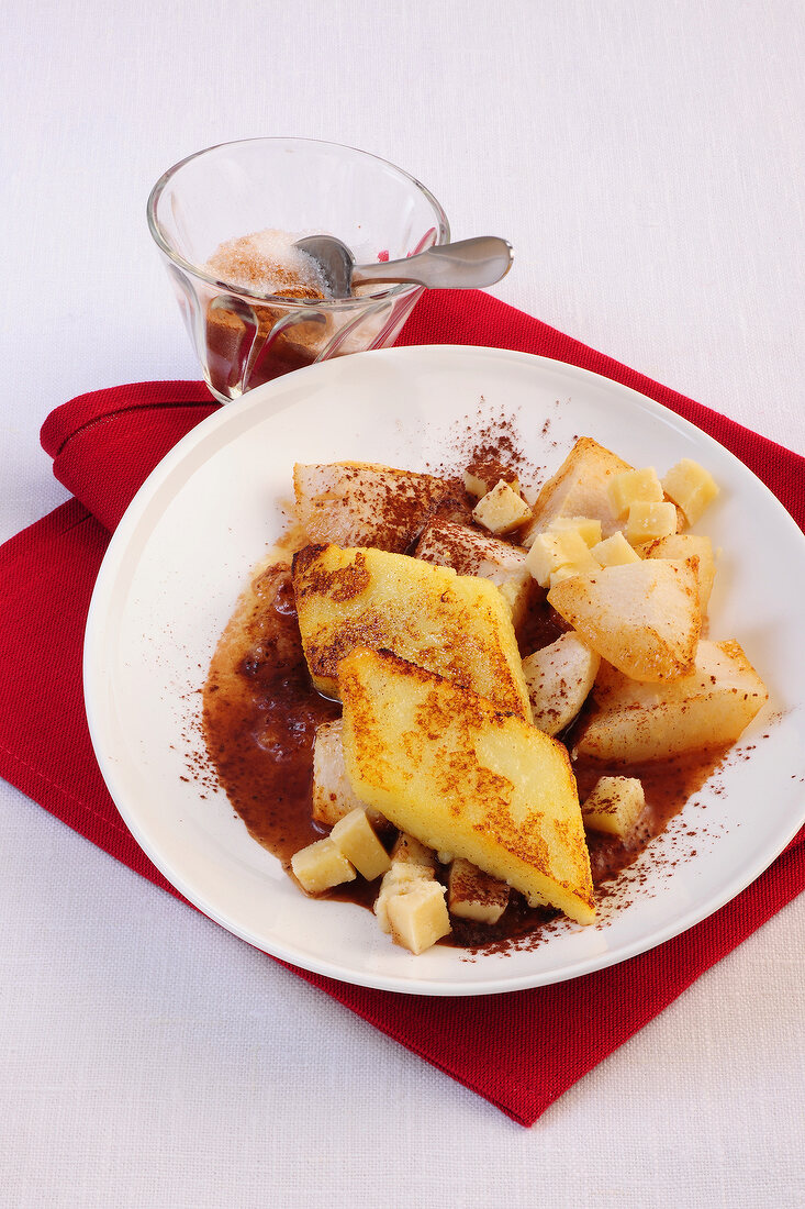 Slices of semolina with pears and marzipan compote on plate