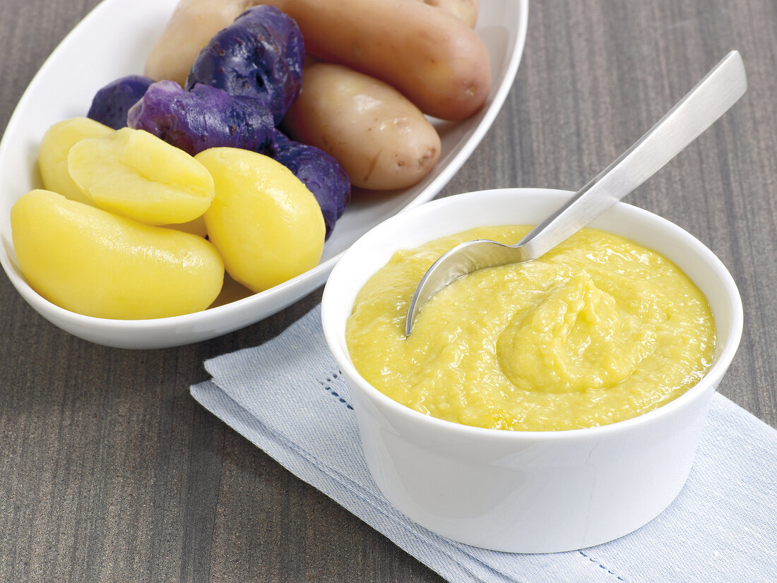 Boiled potatoes with sauce in serving dish