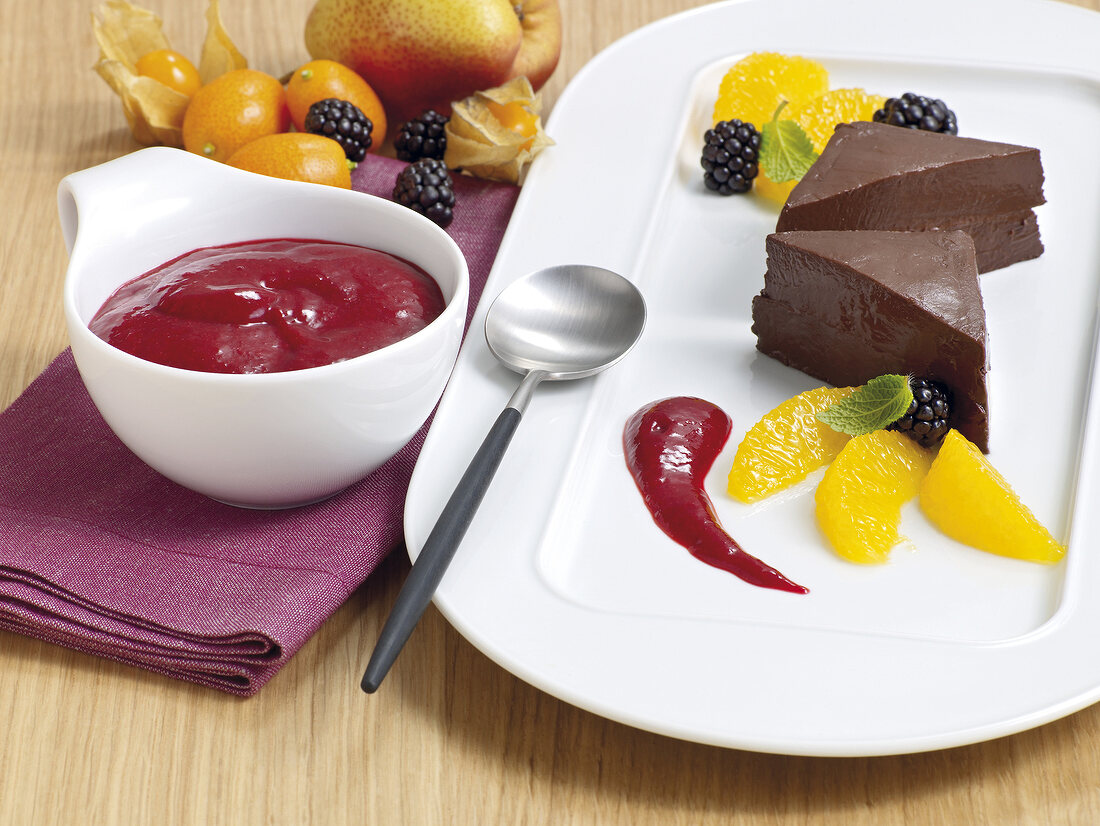 Piece of chocolate mousse with berry sauce