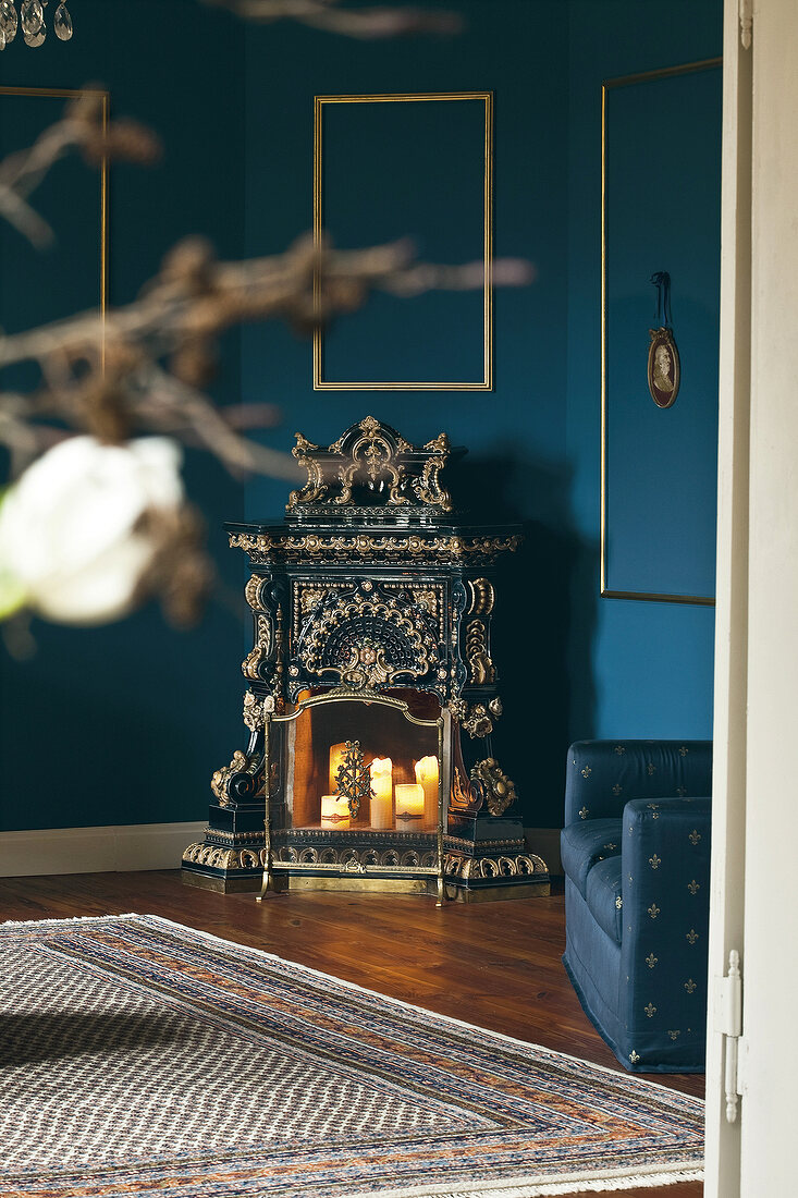 Ornamental fire place against blue wall