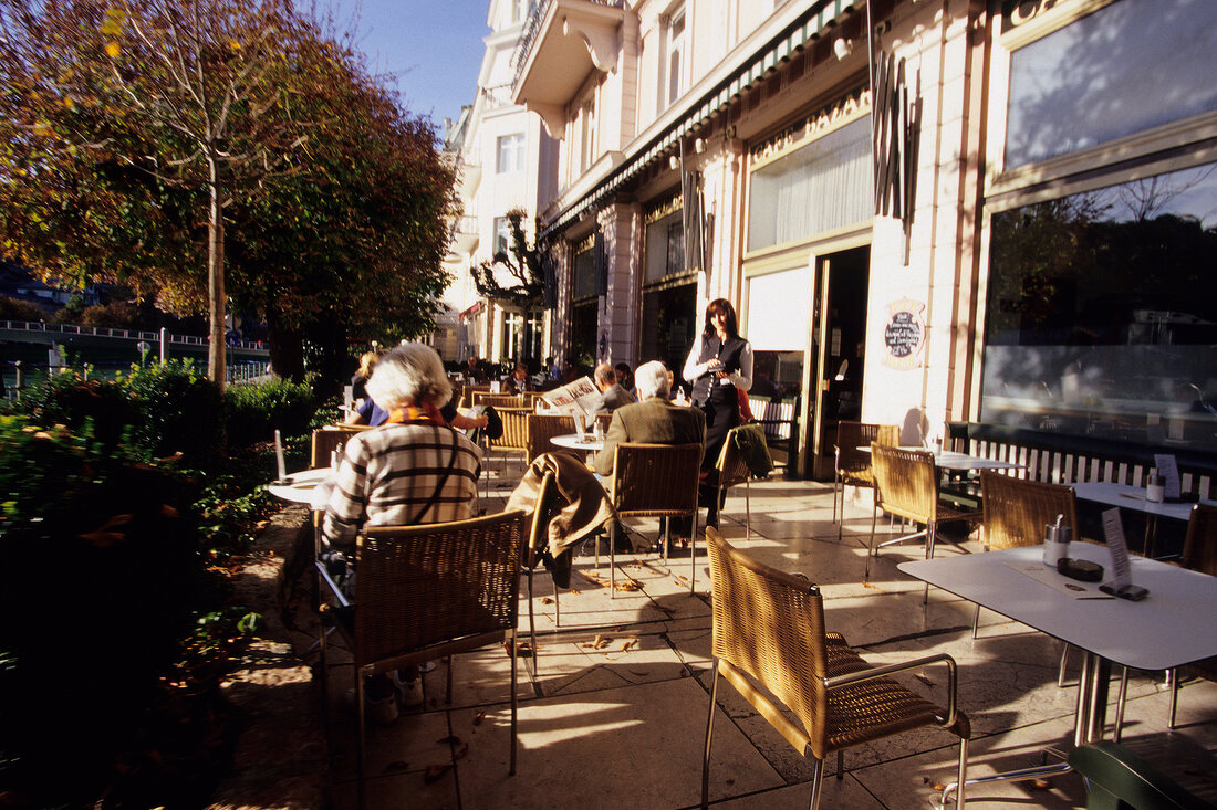 People at cafe Terrace at Bazar Elisabethufer, Salzburg, Austria