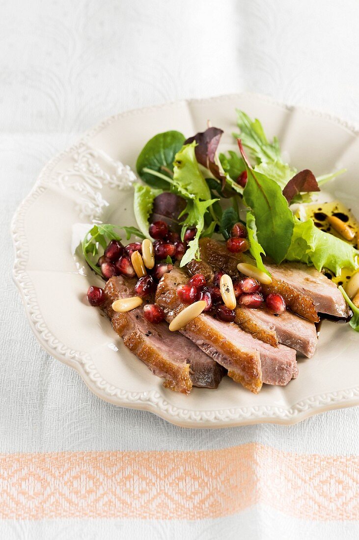 Mixed leaf salad with goose breast and pomegranate seeds