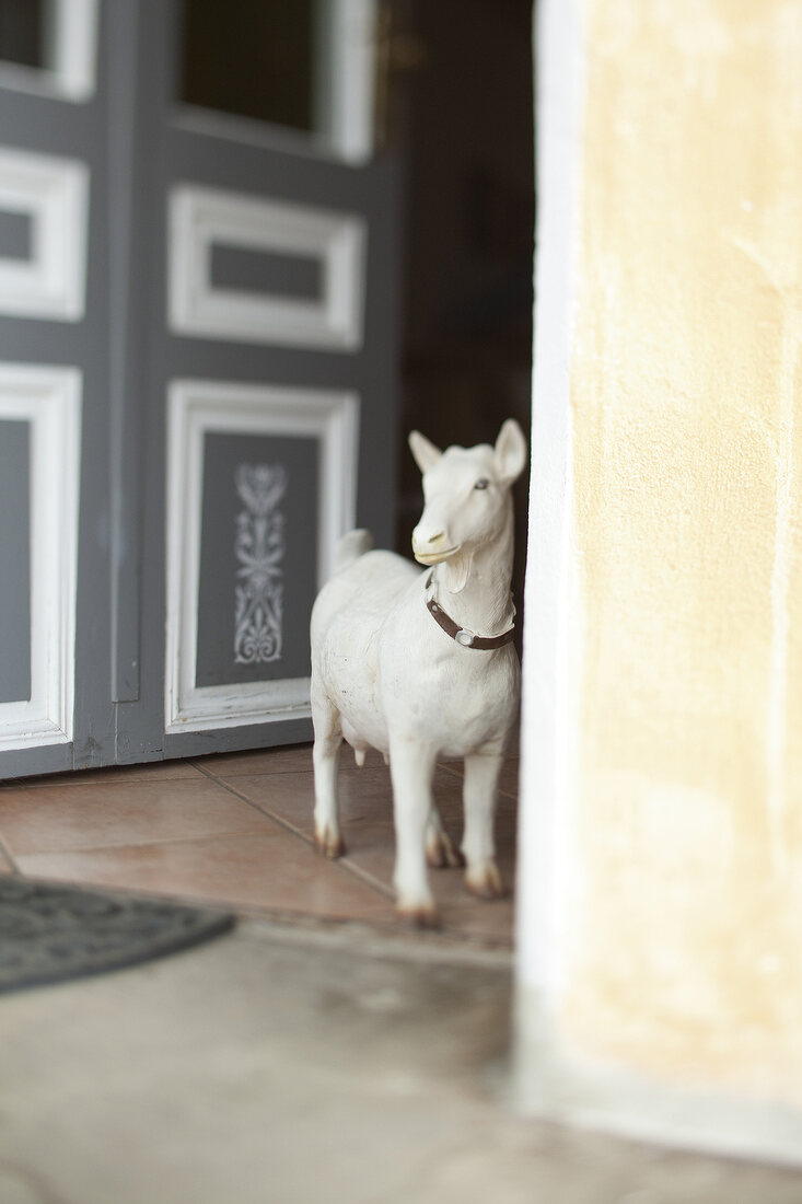 Goat figurine at entrance of door