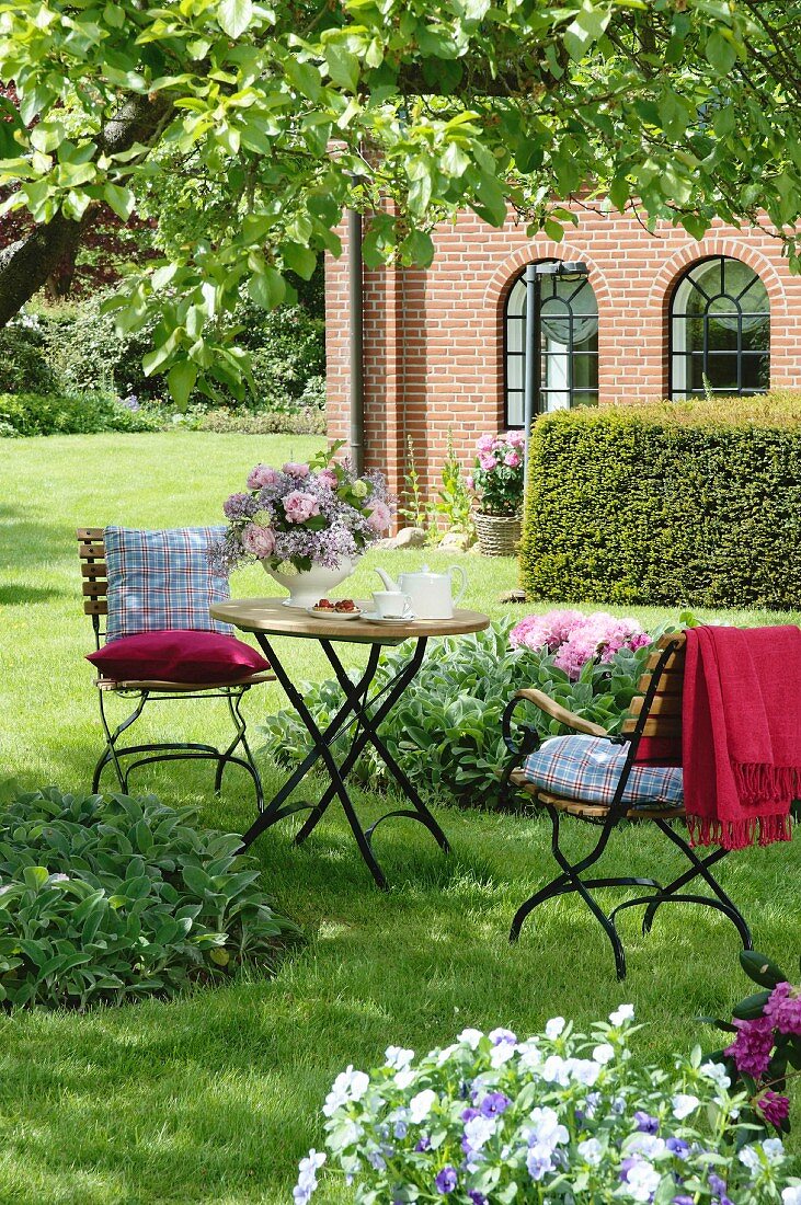 Fontenay table and chairs (by Garpa) below apple tree; house in background