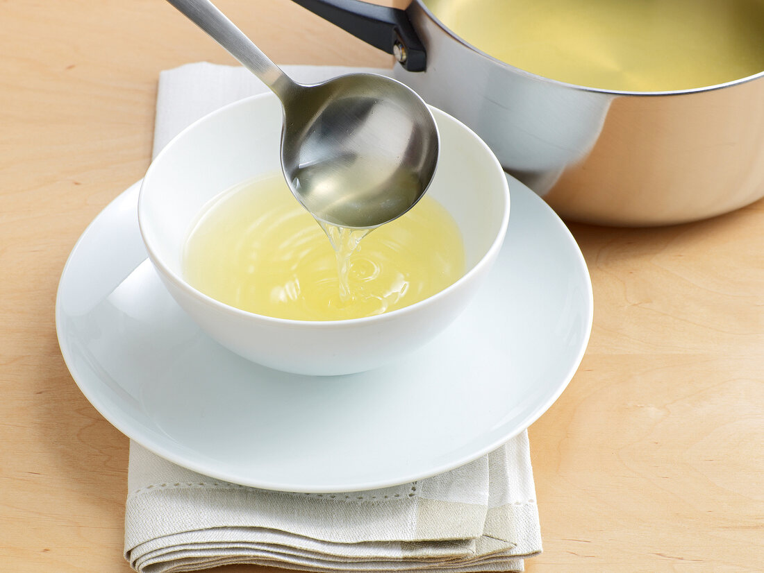 Pouring stock in bowl with ladle, step 5