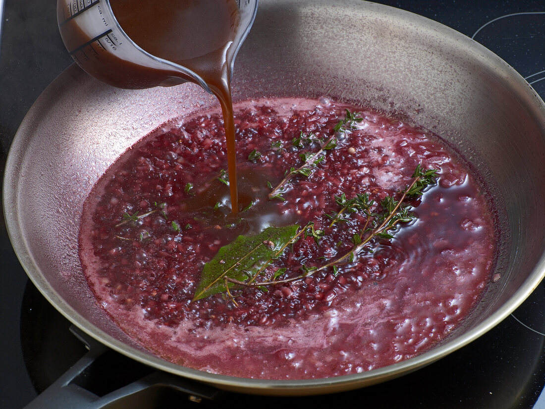 Adding liquid in pan with mixture for preparation of sauce, step 2