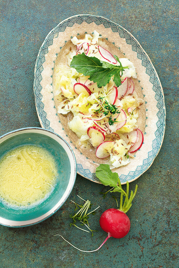 Kohlrabi salad garnish with black cumin on serving dish