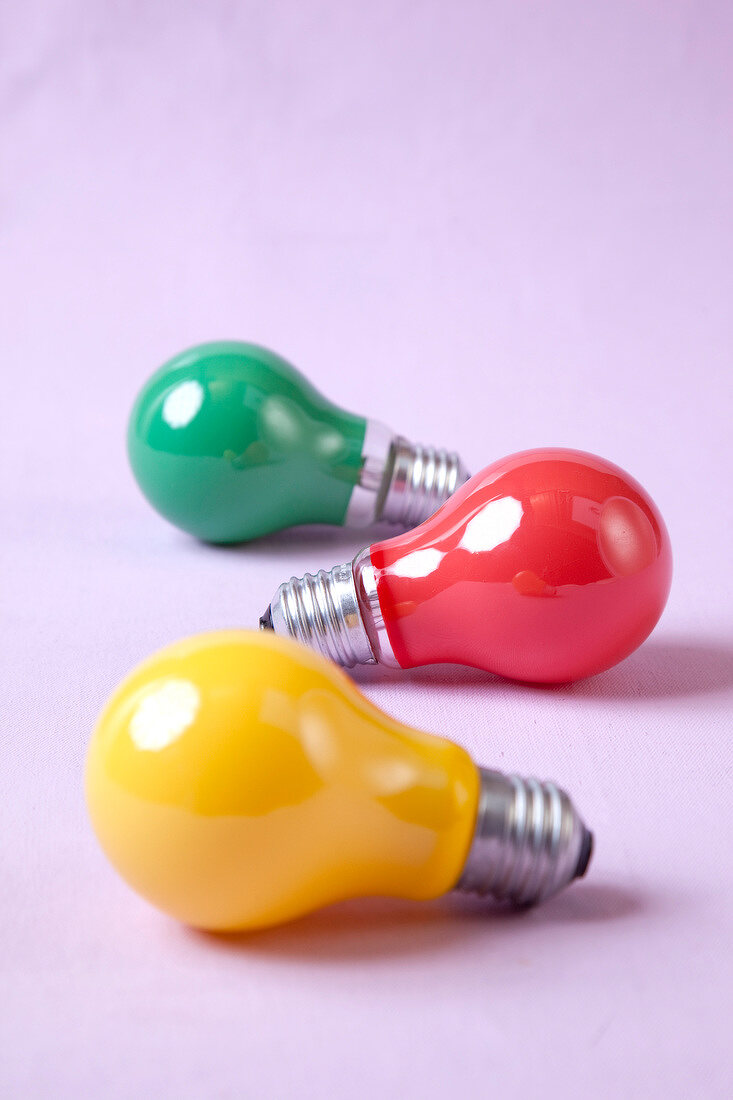 Red, yellow and green bulb on pink background