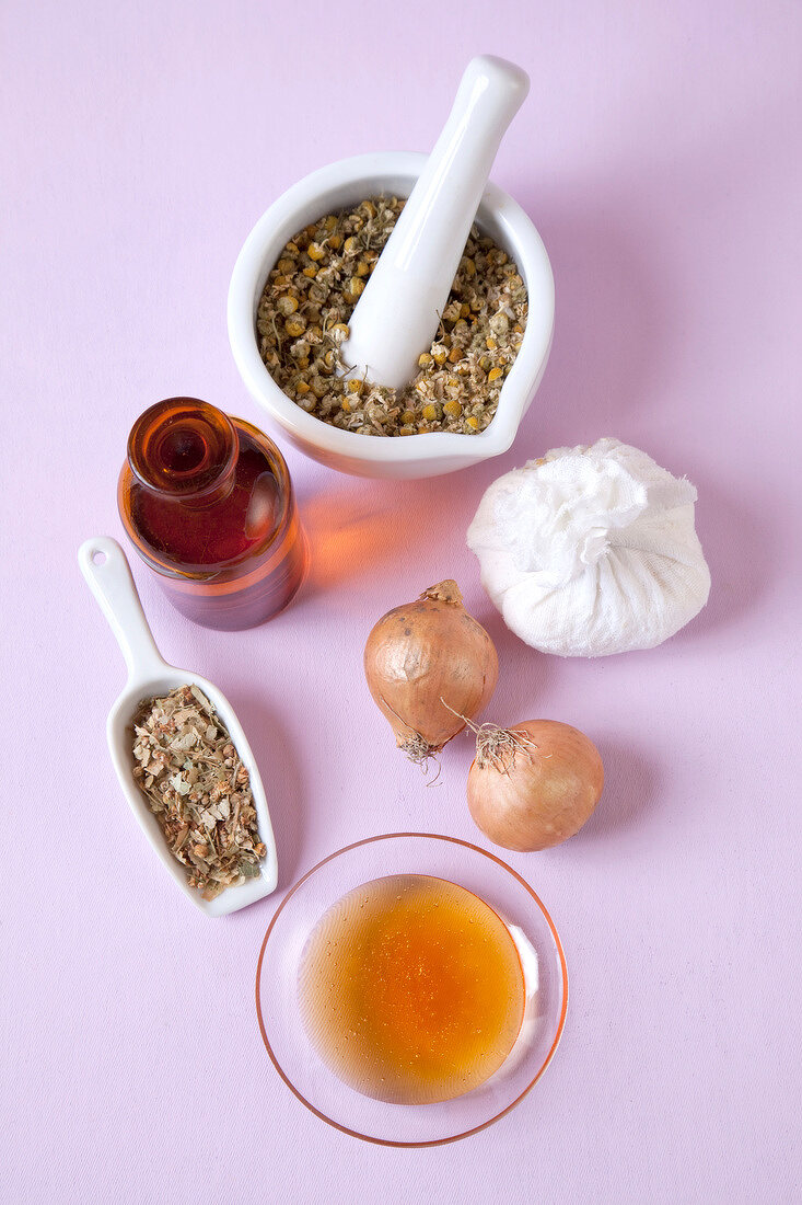 Home remedies - chamomile, onion, vinegar, honey and lime blossom on pink background
