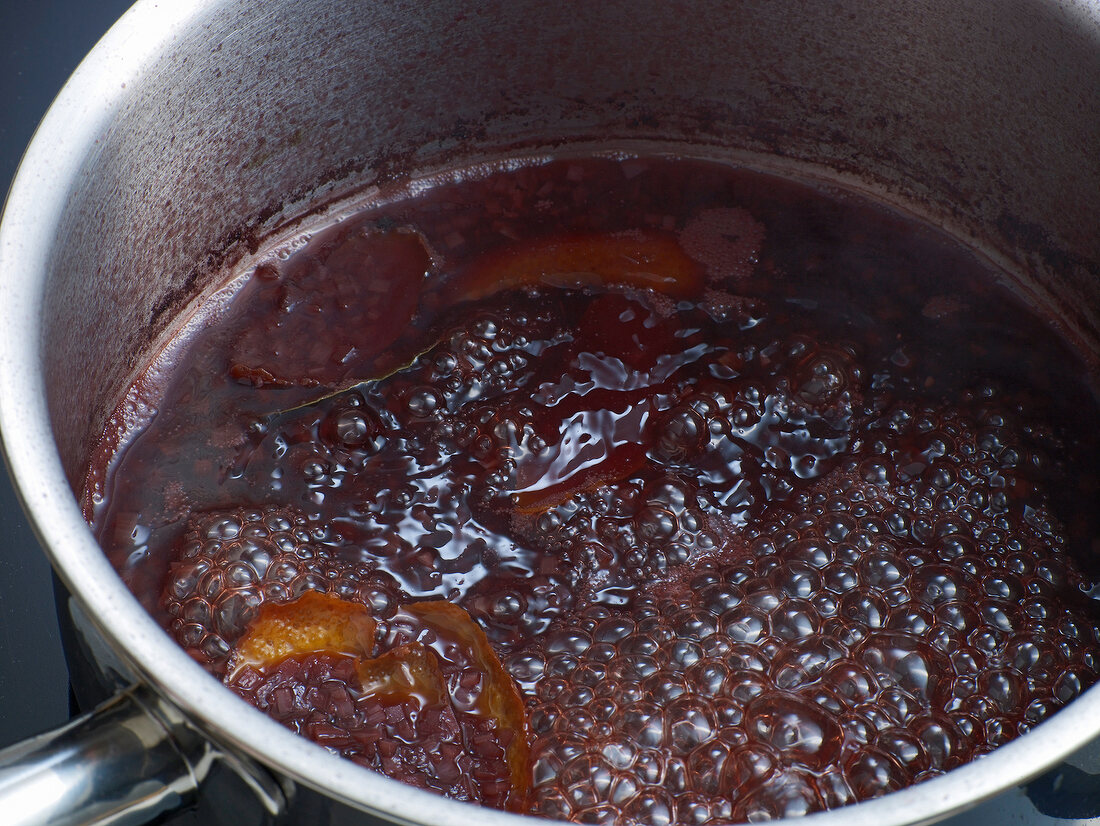 Close-up of mixture being boiled in pan for preparation of bound wild jus, step 3