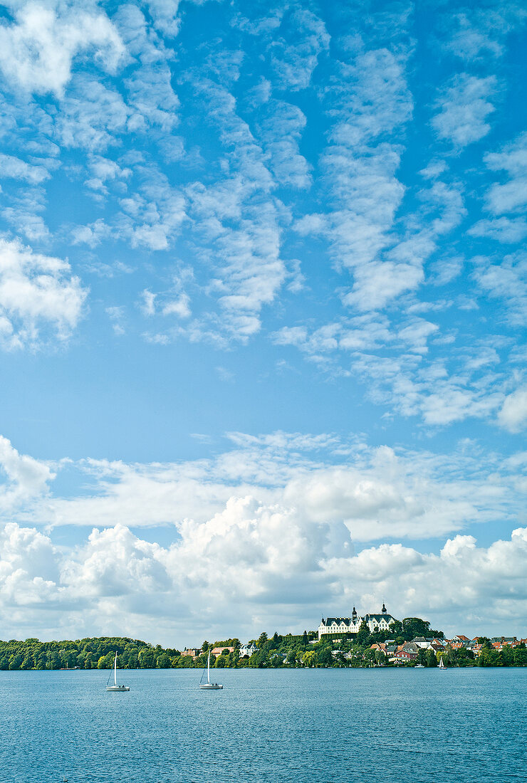 View of Plon Castle with Plon lake and cloudy sky