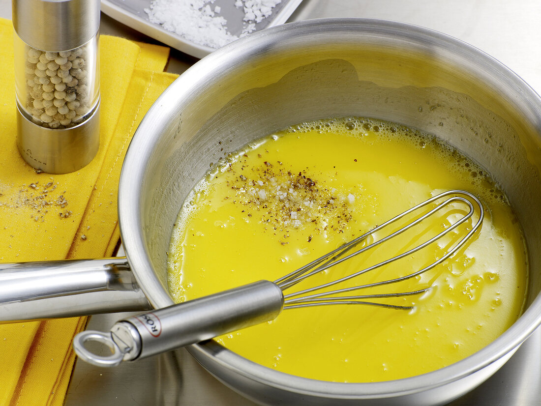 Mixing ingredients with whisk for preparation of white butter sauce, step 3