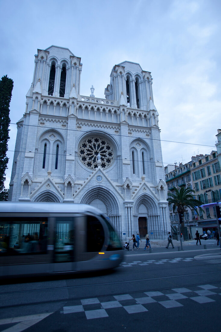 Tram passing in front of Notre Dame Basilica, Nice, France