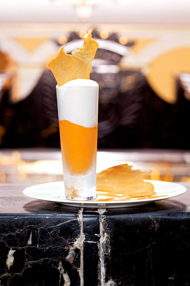 Sea buckthorn sorbet with yogurt foam and yoghurt chips in glass