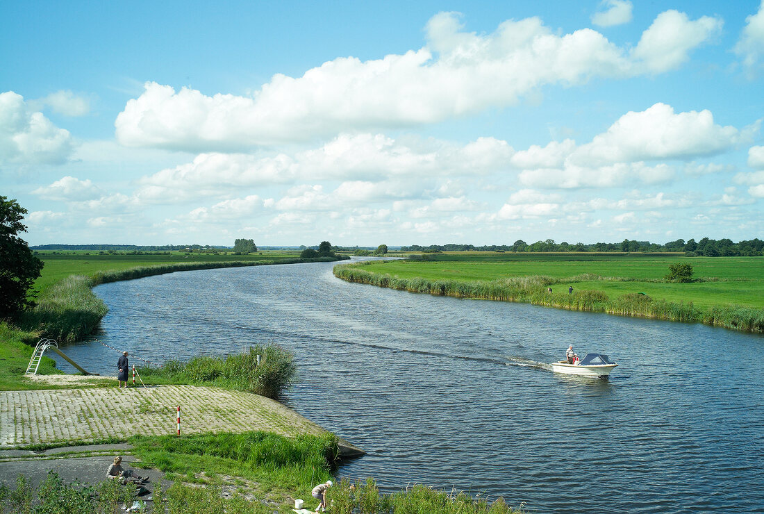 View of boat in Eider river at Breiholz, Baltic Sea Coast, Germany