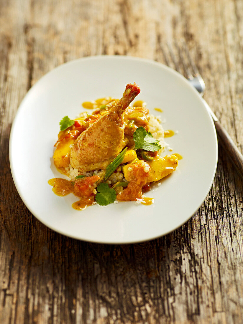 Chicken curry with pearl barley on plate