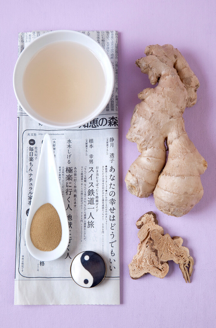 Various herbal Japanese healing medicines on pink background, overhead view