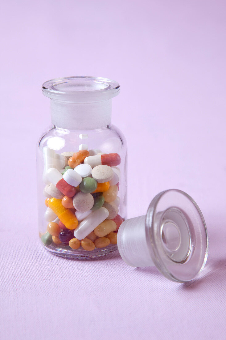 Tablets and capsules in glass bottle