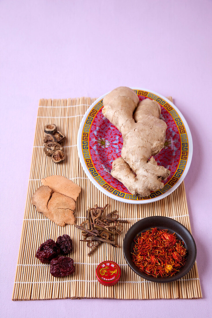 Traditional Chinese Medicine - ginger root, saffron thread and tiger balm, overhead view