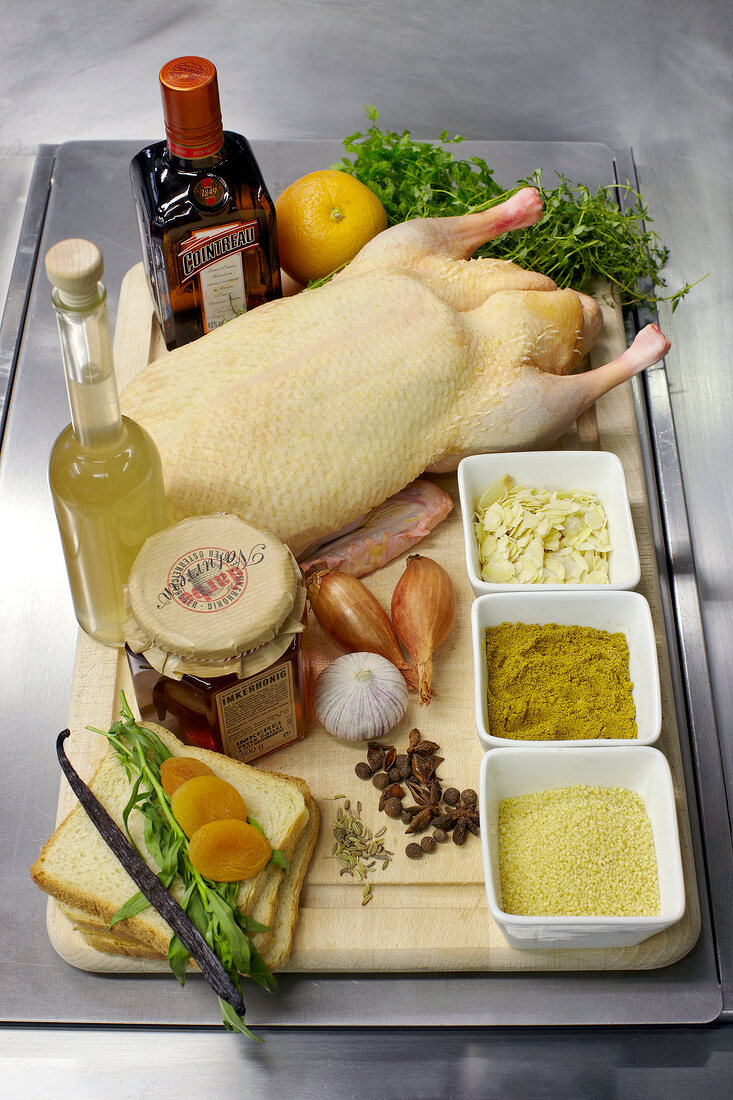 Stuffed duck with couscous, dried apricots and others ingredients on chopping board