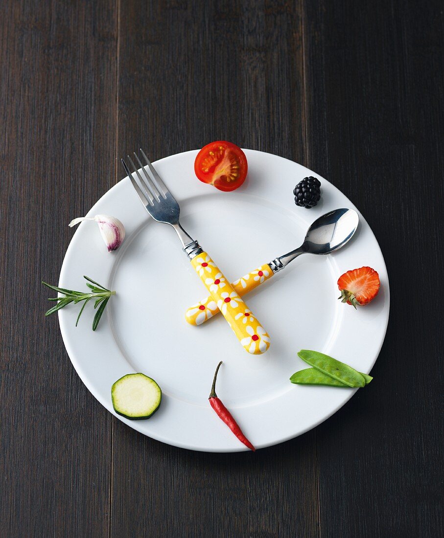 Expresskochen: Symbolische Uhr aus Teller, Obst Gemüse & Besteck