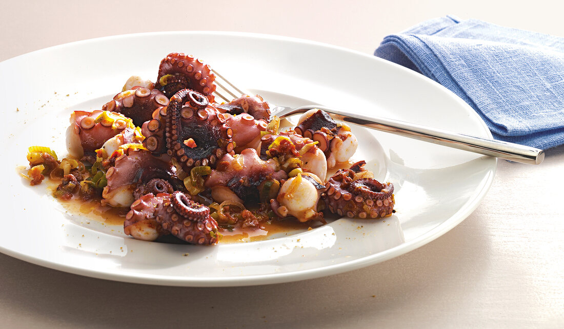 Octopus salad on plate with fork