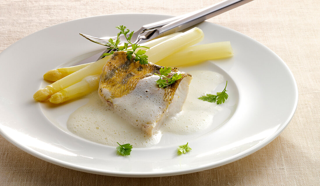 Zander fillet with white wine sauce on plate