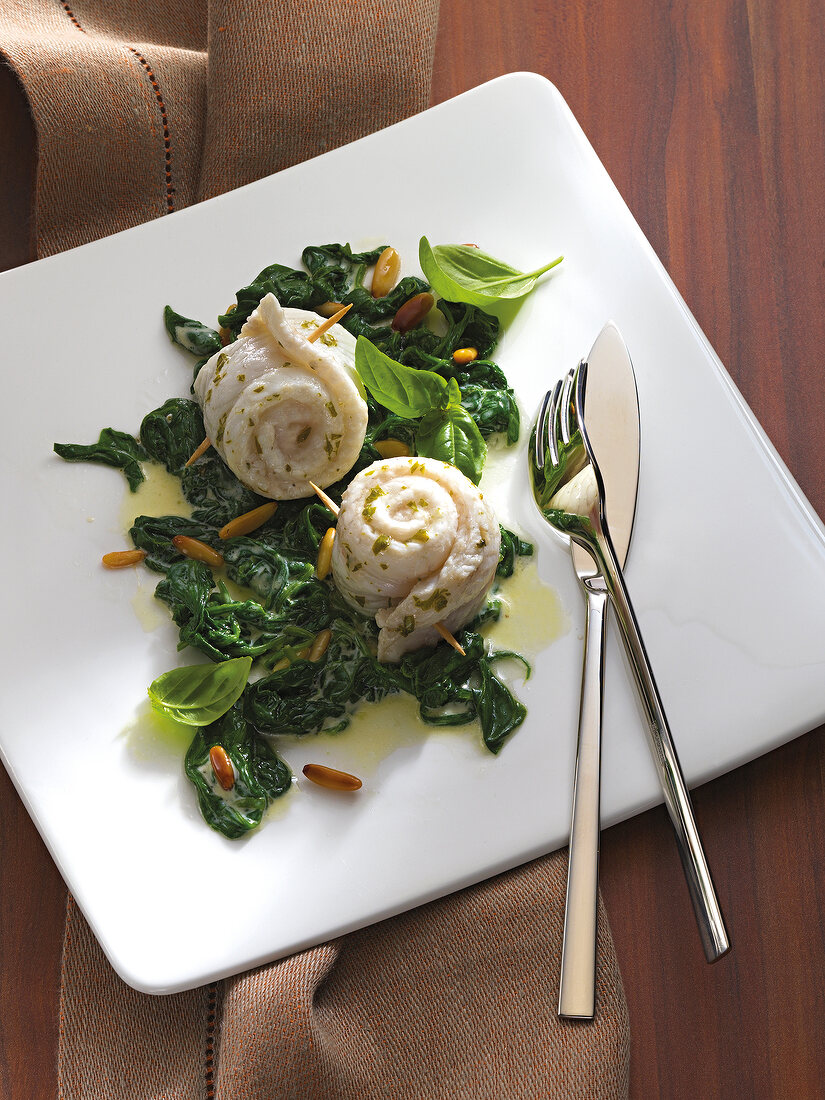 Sole rolls with spinach on plate
