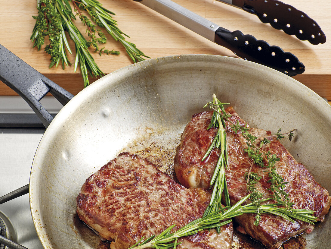 Fillets with herbs being fried in saucepan, step 1