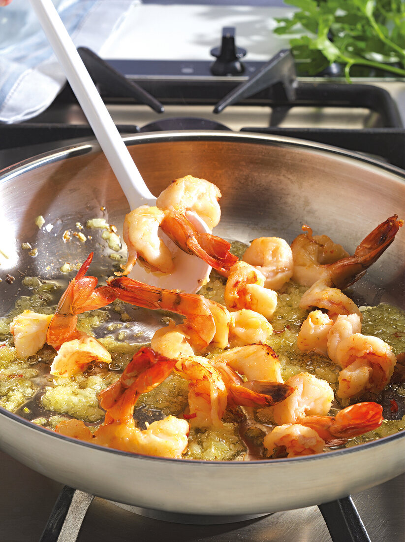 Close-up of shrimps being fried in saucepan