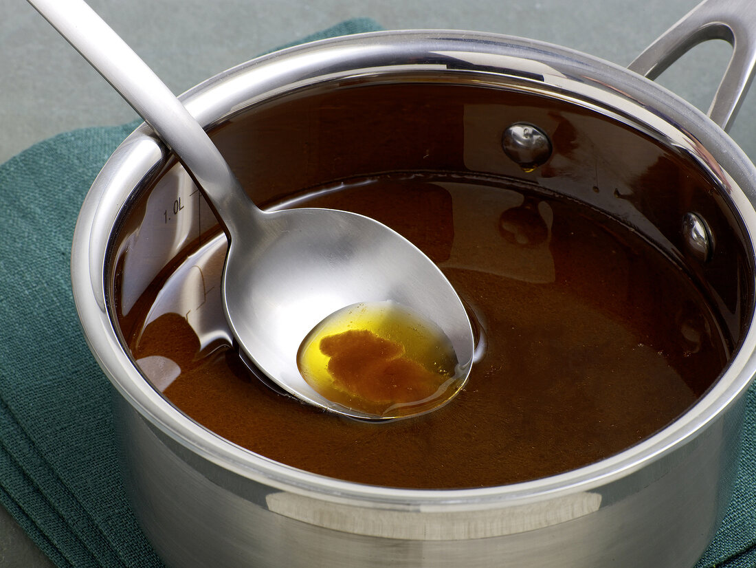 Close-up of sauce with too much oil in saucepan