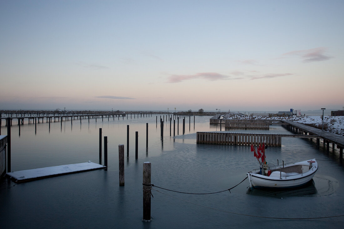 Fishing boats moored at frozen water at Gelting at Schleswig-Holstein, Germany