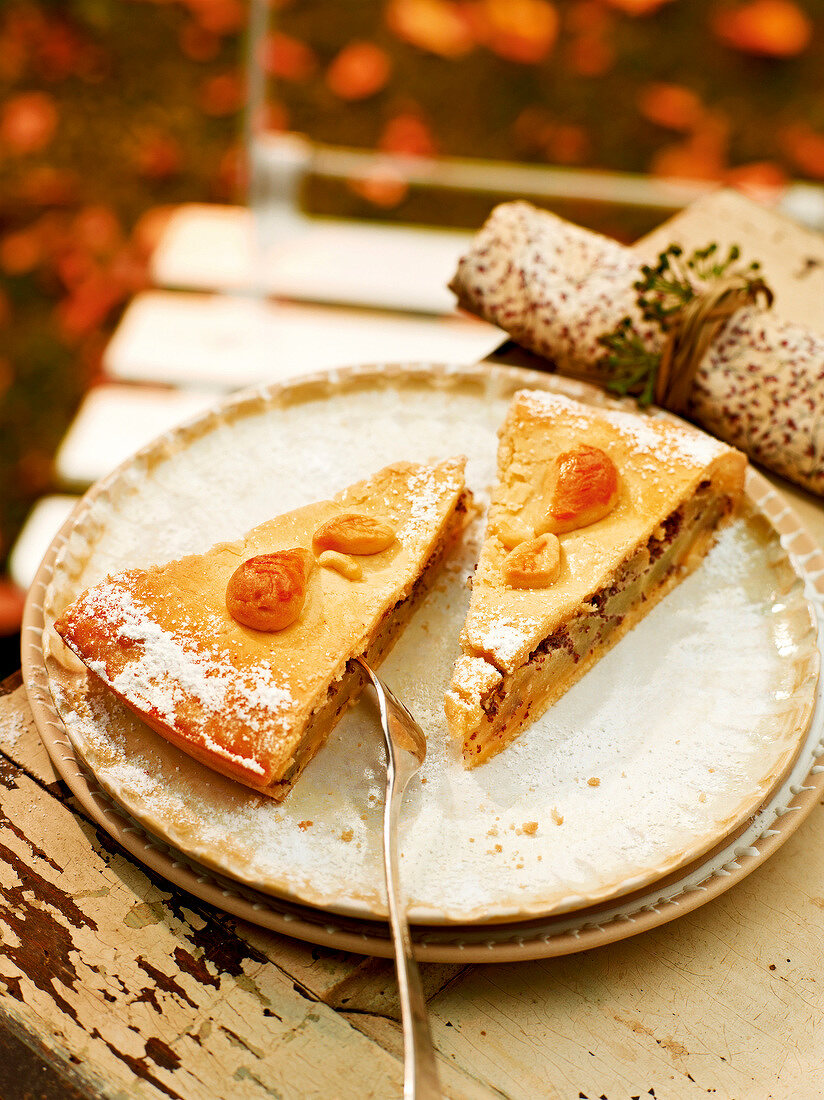 Pear and poppy seed pie on plate, garden kitchen