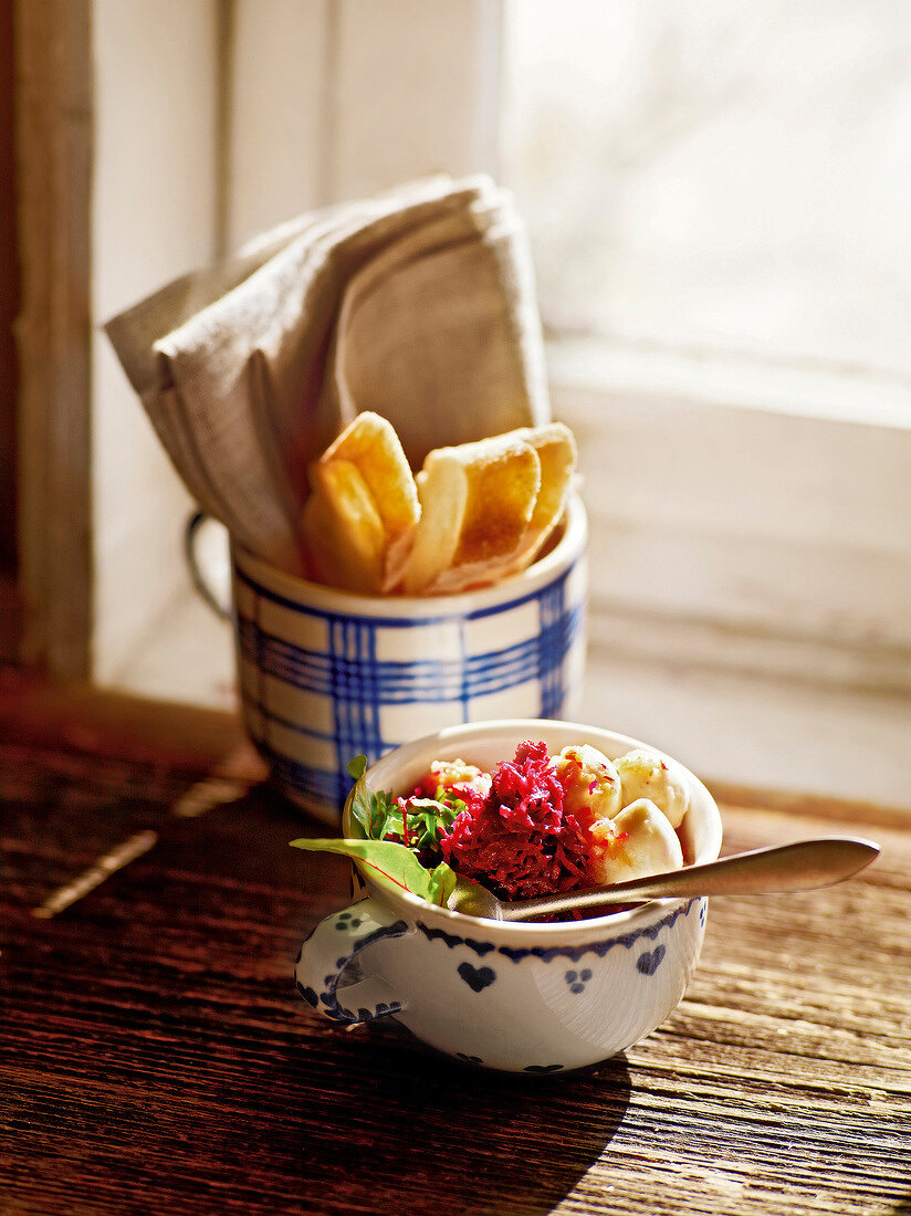 Beetroot salad with mozzarella cheese in cup, garden kitchen