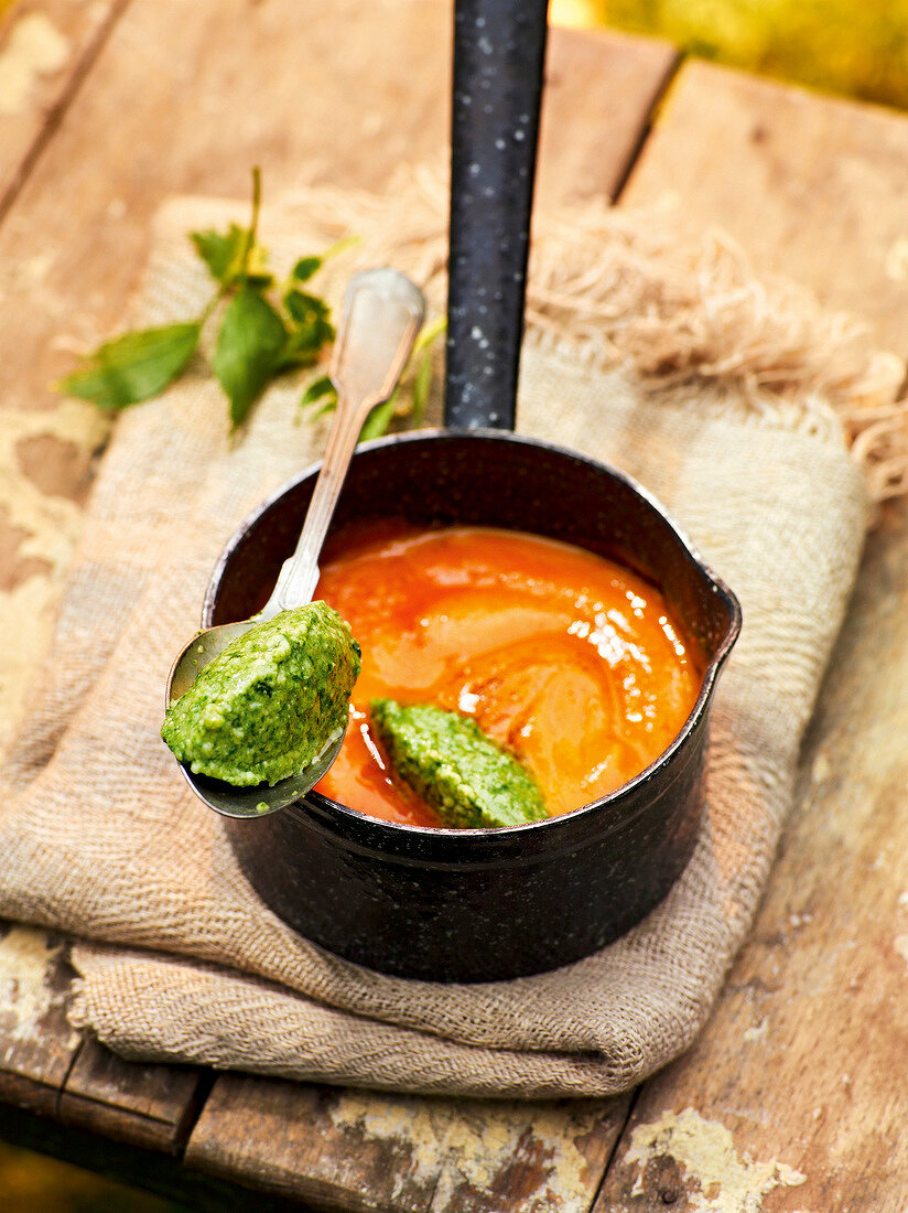 Herb malfatti with pumpkin sauce in pot, garden kitchen