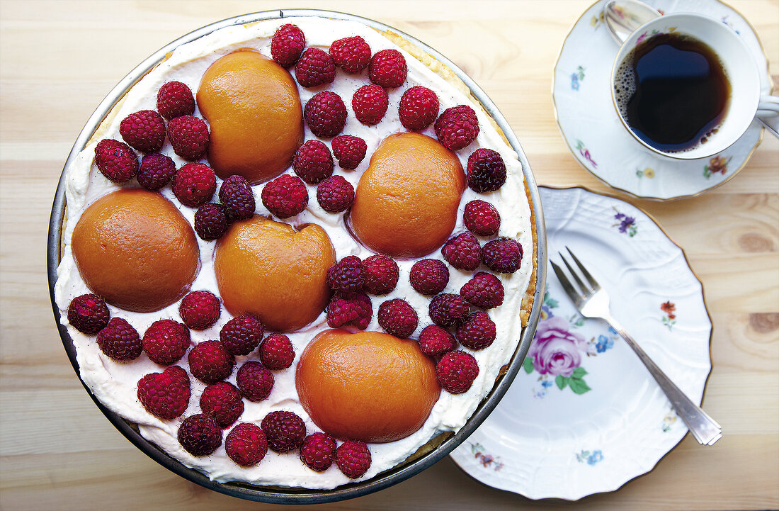 Puff pastry pie with peach and raspberry on plate