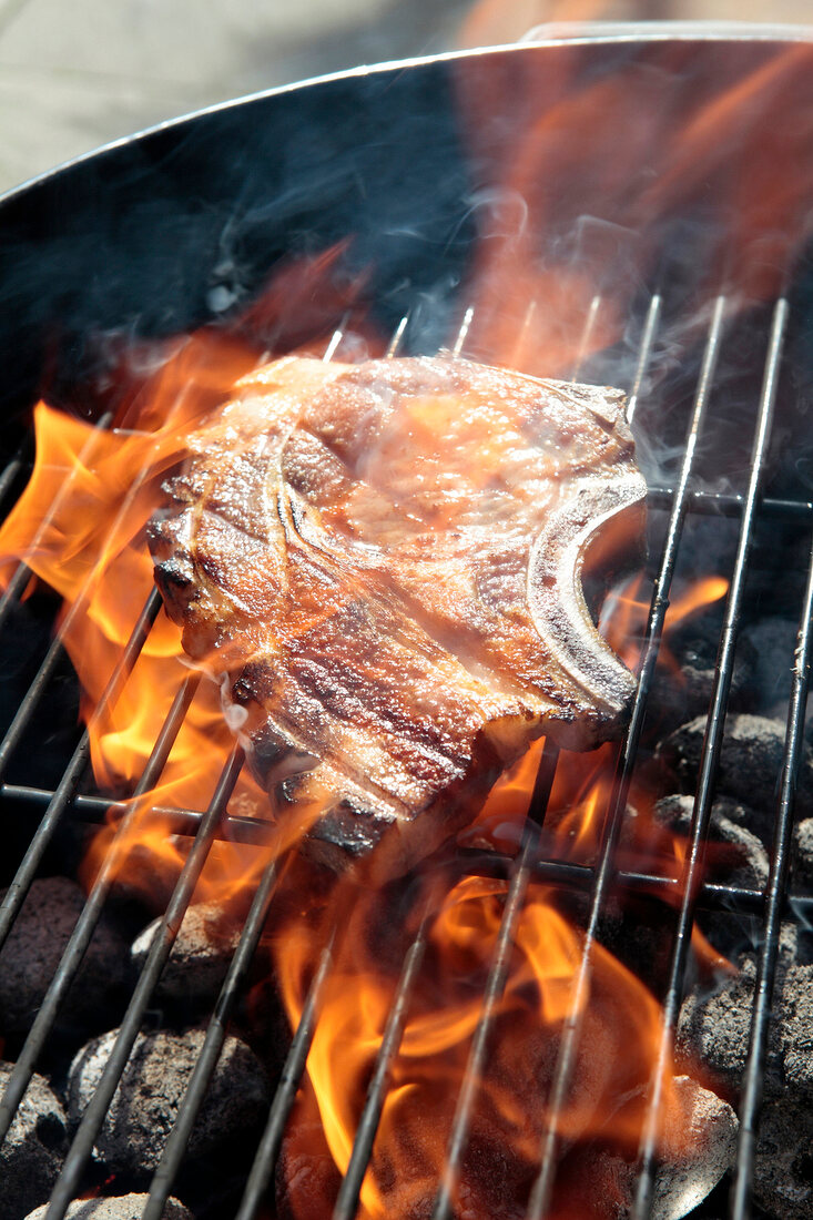 Steak auf dem Grillrost, Flamme