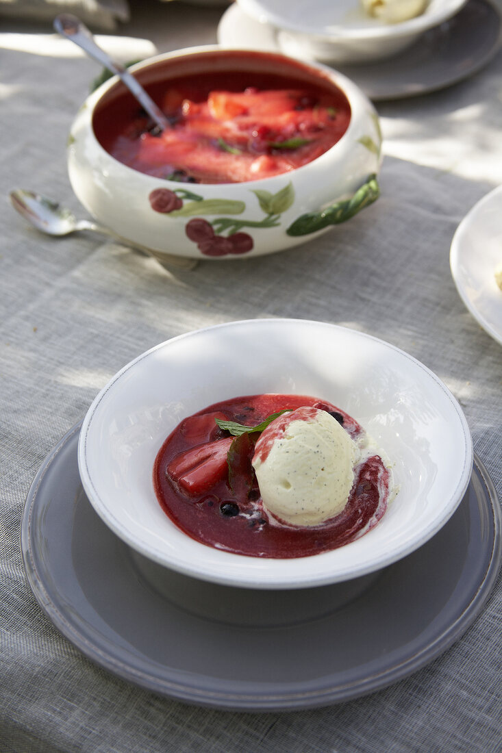 Cold berry soup with vanilla ice cream in bowl
