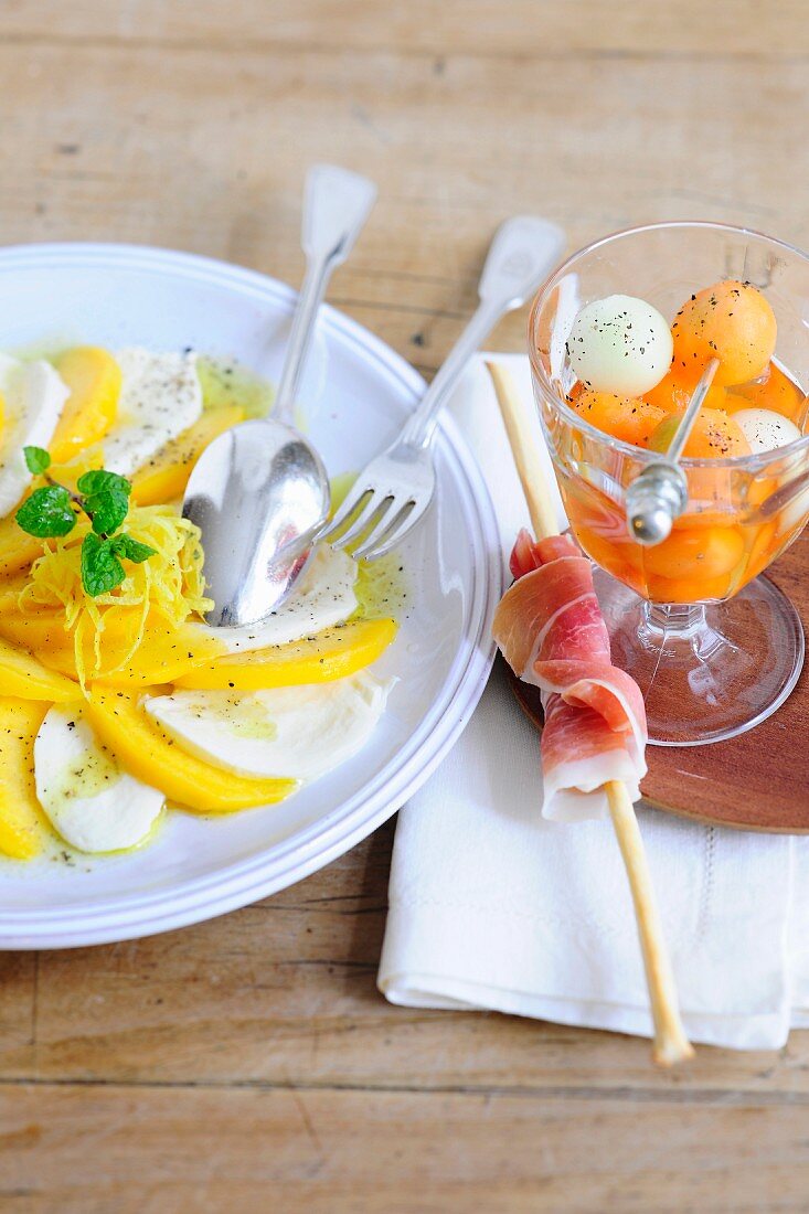 Peach caprese, and melon with ham grissini